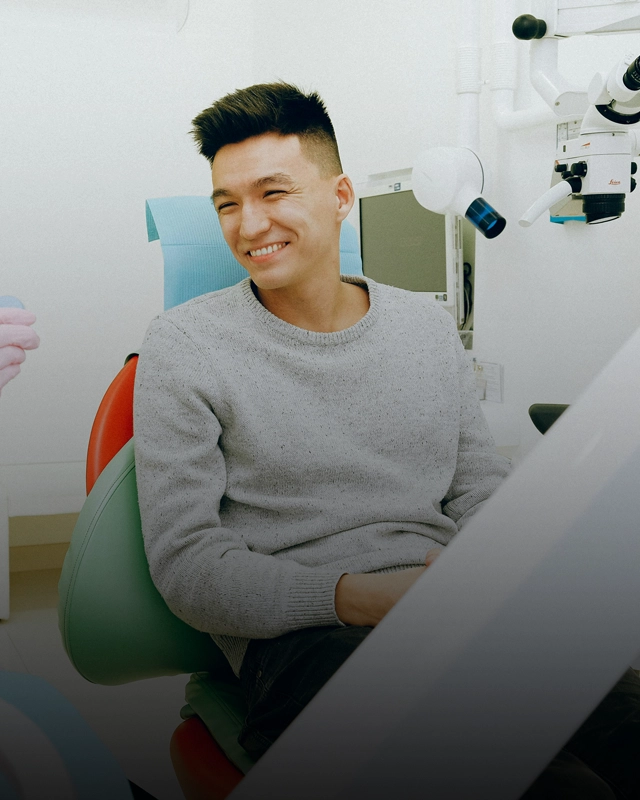 A male patient in a dental exam chair